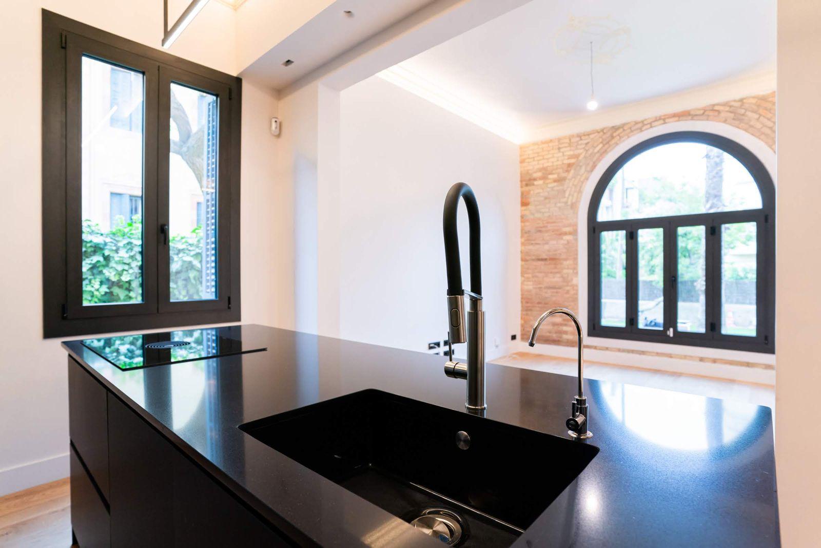 Kitchen island with arched window and garden view