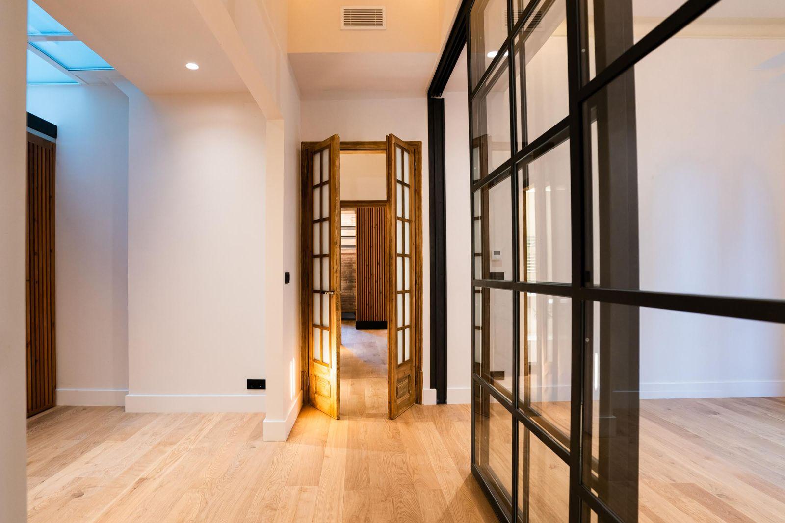 Hallway with original wooden doors and Crittall partitions